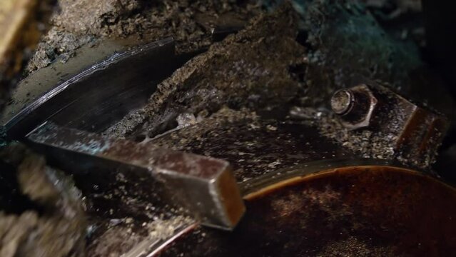 Pressing machine rotates, wringing oil and squeezing out the waste. Press machine crushes and grinds sunflower kernels extracting oil and oilcake. Production equipment in factory. Closeup. Slow motion