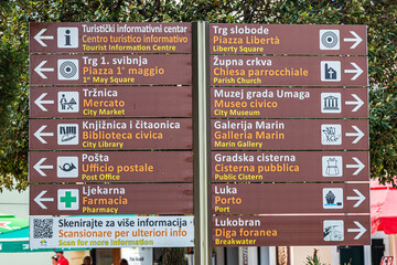 Street signs marking the direction to the sites to visit in Umag, Croatia