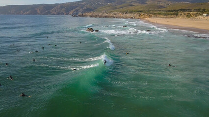 
surfer surfing a perfect wave at Guincho beach in Cascais near Lisbon, Portugal