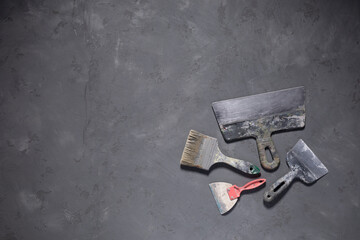 Putty knife work tool on cement floor. Tool construction renovation concept at concrete background