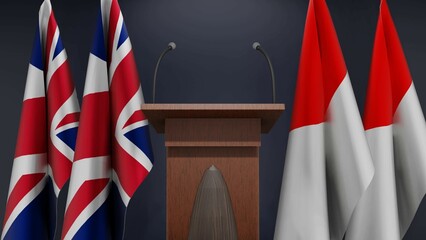 Flags of United Kingdom and Indonesia at international meeting or negotiations press conference. Podium speaker tribune with flags and coat arms. 3d rendering