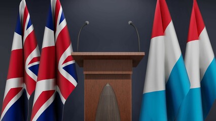 Flags of United Kingdom and Luxembourg at international meeting or negotiations press conference. Podium speaker tribune with flags and coat arms. 3d rendering