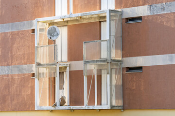 Square exterior wall construction, white metal structure on the facade of a building