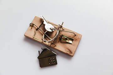 Mousetrap with house key. Top view. Fraud or crime in real estate