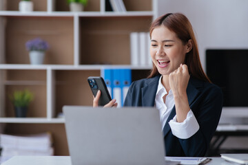 Business woman happy and cheerful for successful on project via mobile phone in office space.