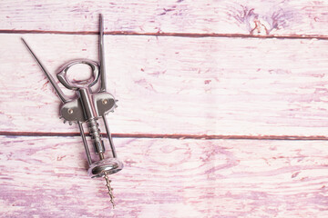 Corkscrew on a wooden background