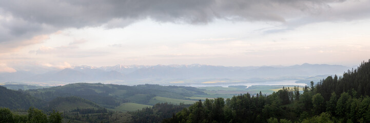 Beautiful panorama of green valley with mountains in the distance catching the sunset light,Slovakia