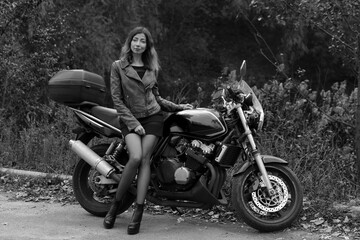 Fototapeta na wymiar Beautiful lady with a motorcycle in black and white