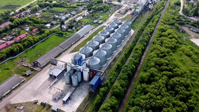 Modern grain silo elevator, view from a height and from different angles. Grain storage tanks on top Grain storage in large cells industrial zone for grain processing silos for agribusiness