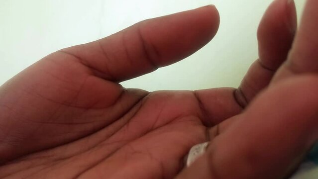 Twitchy thumb of an African woman footage. Involuntary muscle contraction and relaxation. Health issues. Benign. Black.