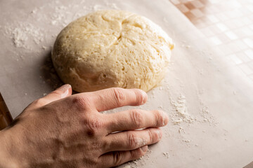 To bake bread. Bakery. Baker kneading dough