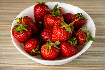 ripe, sweet strawberries on the table in a plate