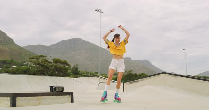 One cheerful female roller skater dancing and spinning in a skate park rink outside. Trendy cool joyful urban skater having fun performing tricks while enjoying hobby and feeling free and energetic