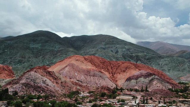 Altiplano landscape. Time lapse of the famous seven colors hill and Purmamarca village in Jujuy, Argentina. View of the colorful mountains and fast moving clouds passing by. 