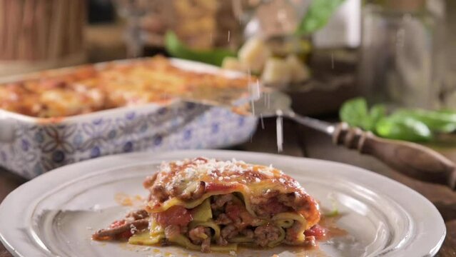 asagna with pesto. Italian lunch, homemade green lasagna with spinach in the dough, ragu - meat sauce, bechamel and parmesan cheese. Village dining atmosphere in Italy. Hot steam over food. footage