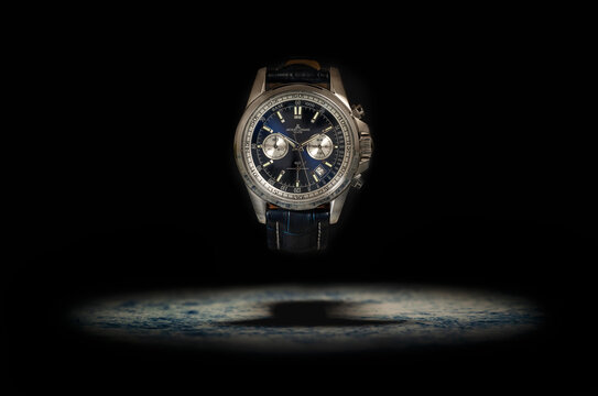 Belgrade, Serbia - June 24, 2022. Studio shot of a blue fancy luxury Men watch Jacques Lemans on the black background. Accessories for men in the business style.