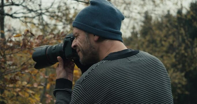 Landscape Photographer taking pictures during a moody autumn day in the hills of Mondsee, Austria