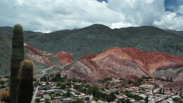 Altiplano landscape. Time lapse of the famous seven colors hill and Purmamarca village in Jujuy, Argentina. View of the colorful mountains and fast moving clouds passing by. 