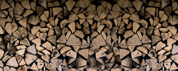 A stack of firewood. Wooden background. Texture