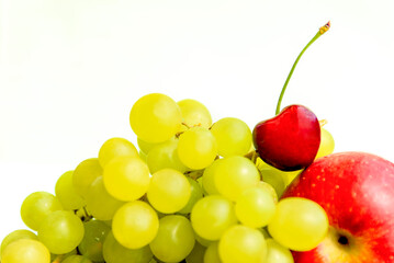 Cherry berry, grape and red apple on a white background. Juicy ripe fruits close-up.