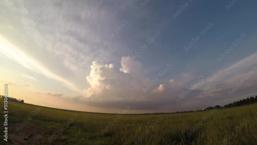 Sticker Boiling turrets of a storm cloud. Time lapse movie of a Cumulonimbus storm cloud over the Dutch countryside in the evening hours, which is moving away.