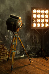 Large vintage retro spotlight in the interior in the loft style. Video movie light in the studio on...