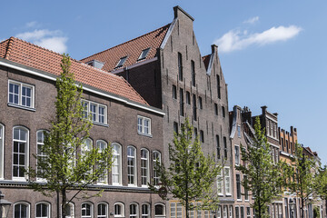 Fototapeta premium Canal view with old traditional Dutch houses in Leiden on beautiful sunny day. Leiden, North Holland, the Netherlands.
