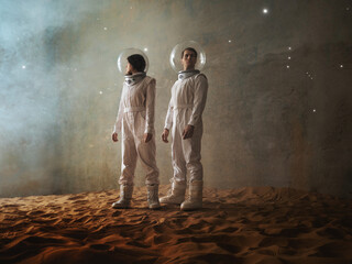 Astronauts in an empty colony on a deserted planet, a man and a woman in white futuristic spacesuits explore the area © Ulia Koltyrina