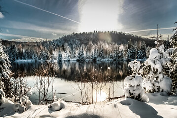 Fototapeta premium winter scene abroad a lake in rural country of Quebec, Canada
