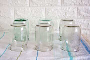 Several clean, empty half-litre glass jars sit upside down on the kitchen table. Time to preserve...