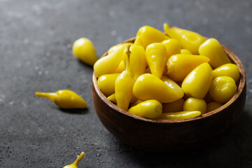 Fresh yellow chubby hot pepper pickle in bowl, marinated or canned peppers