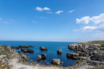 Fototapeta na wymiar rock formations with blue cloudy sky