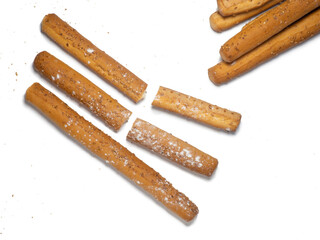 Sesame biscuits on a white background. Biscuits are elongated in the form of sticks. Bread...
