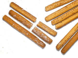 Sesame biscuits on a white background. Biscuits are elongated in the form of sticks. Bread products. Flour products. Healthy food.