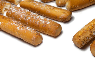 Sesame biscuits on a white background. Biscuits are elongated in the form of sticks. Bread products. Flour products. Healthy food.