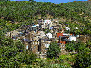 View of the ancient historic stone houses among the green mountains. Piodao, Portugal.