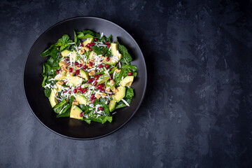 Avocado salad with spinach, pomegranate, walnuts and cheese