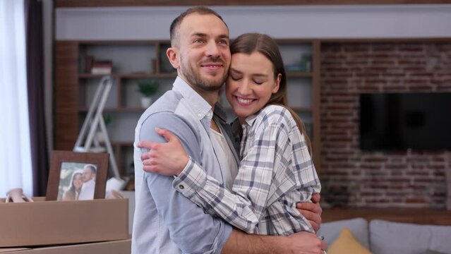 Estate agent giving bunch of keys from new house to young couple. Happy homeowners on relocation day. Real estate and tenancy concept. Loan mortgage for young family.