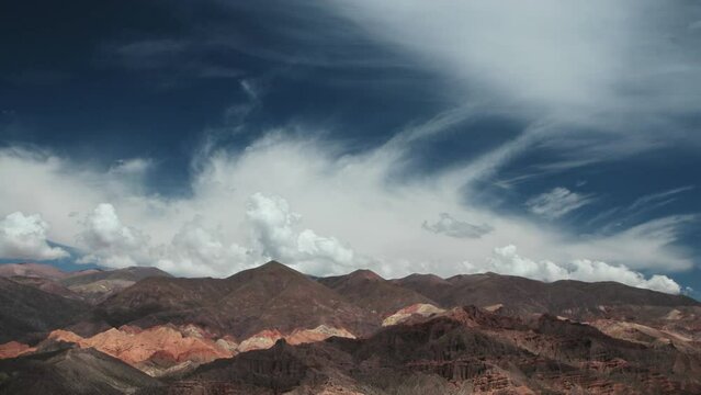 Time lapse in Tilcara, Jujuy, Argentina. View of the Quebrada de Humahuaca mountains under a beautiful sky with fast white clouds passing by. 
