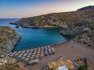 Obraz premium Aerial panoramic view of the famous rocky beach Melidoni in Kythira island at sunset. Amazing scenery with crystal clear water and a small rocky gulf, Mediterranean sea, Greece, Europe.