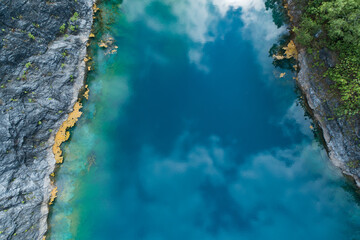 Aerial view of amazing pond in tropical rainforest forest with mountain rocks peak Beautiful water surface in Phang Nga Thailand