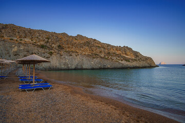 View of the famous rocky beach Melidoni in Kythira island at sunset. Amazing scenery with crystal clear water and a small rocky gulf, Mediterranean sea, Greece, Europe.