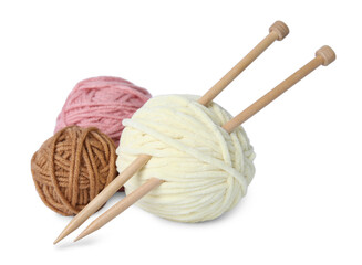 Soft woolen yarns and knitting needles on white background