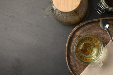 Freshly made buckwheat tea served on grey table, flat lay. Space for text