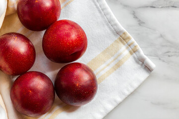 Plumcot. Organic fruits. Vegetarian.
Healthy vegetarian diet. A plumcot is a cross between a plum and an apricot. Organic ripen fresh plumcots. Sweet and juicy fruits. 