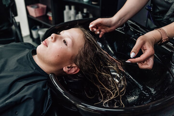 Naklejka na ściany i meble hair care products in the beauty salon, washing hair in the salon