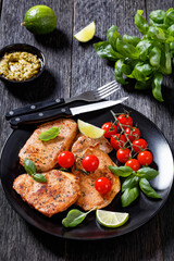 tomato basil pesto fried pork cutlets on plate