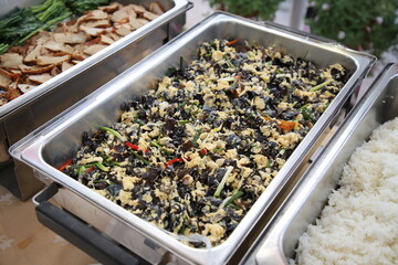 Sauteed Ear Mushroom with Egg in buffet line. The container is a rectangular stainless steel tray....