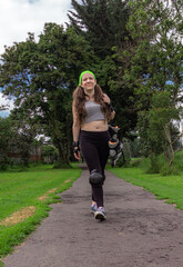 young sporty woman walking with line skates, ready to practice skating.