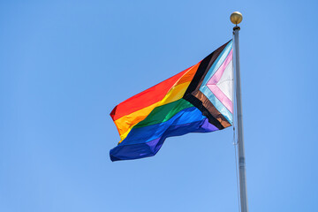 Rainbow flag (LGBT movement) waving in the wind. 
